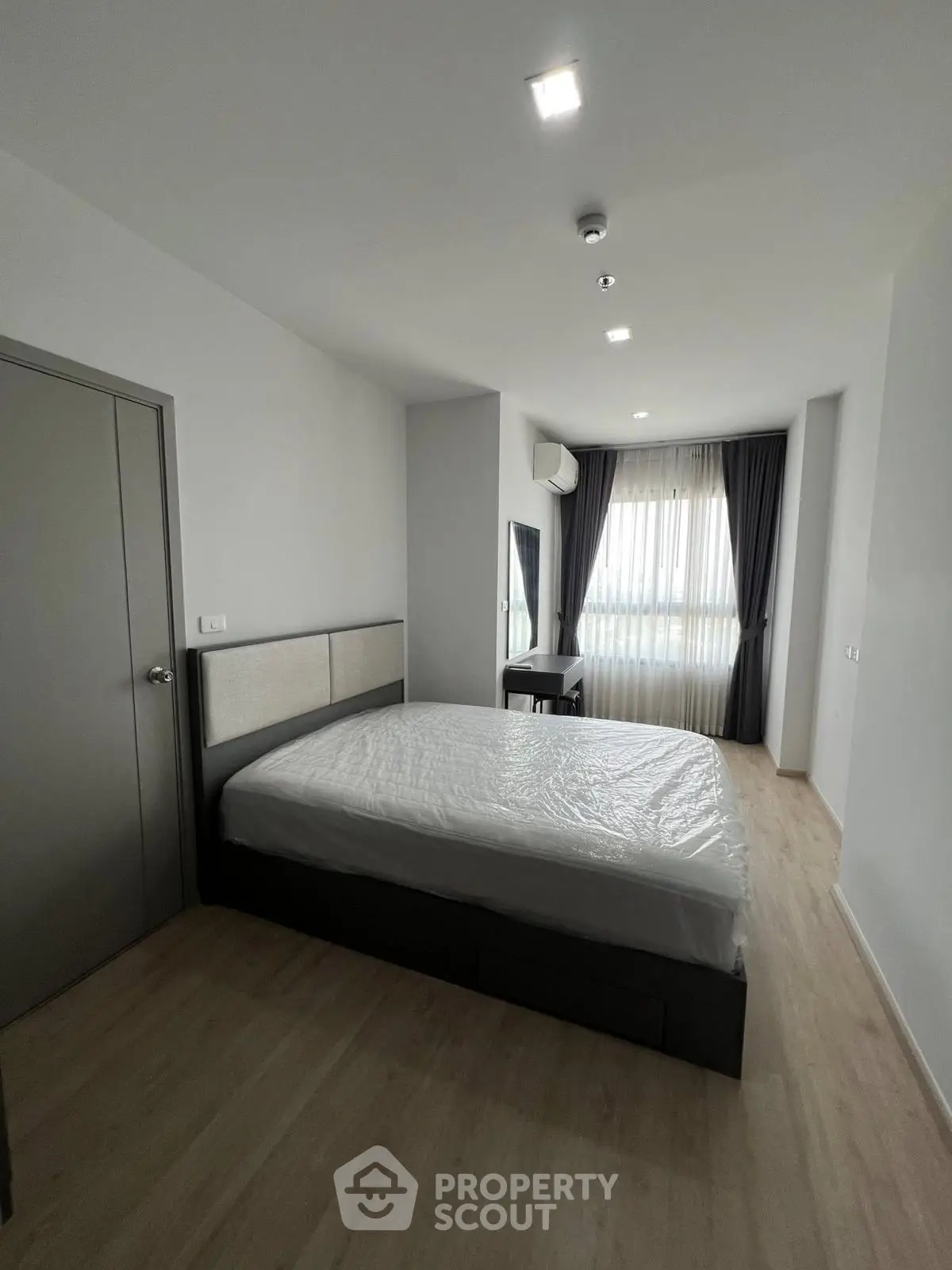 Spacious modern bedroom with natural light and minimalist design