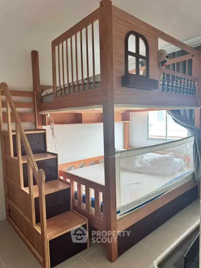 Stylish wooden bunk bed with stairs in a cozy bedroom, perfect for maximizing space and comfort.