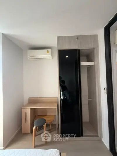 Modern bedroom with sleek furniture and air conditioning in a stylish apartment.