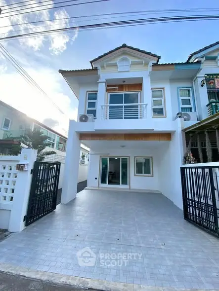 Charming two-story house with modern facade and spacious driveway in a serene neighborhood.