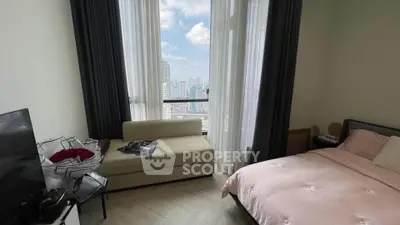 Modern bedroom with city view, featuring large windows and cozy furnishings.