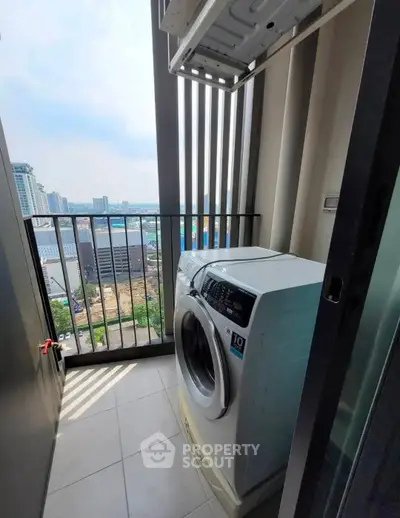 Modern apartment balcony with washing machine and city view, perfect for urban living convenience.