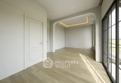 Spacious modern living room with elegant wooden flooring and large windows