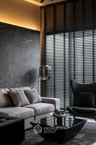 Luxurious modern living room with elegant decor and stylish furniture, featuring a plush sofa and designer lighting.