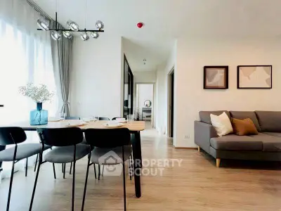 Modern open-plan living and dining area with stylish decor and natural light.