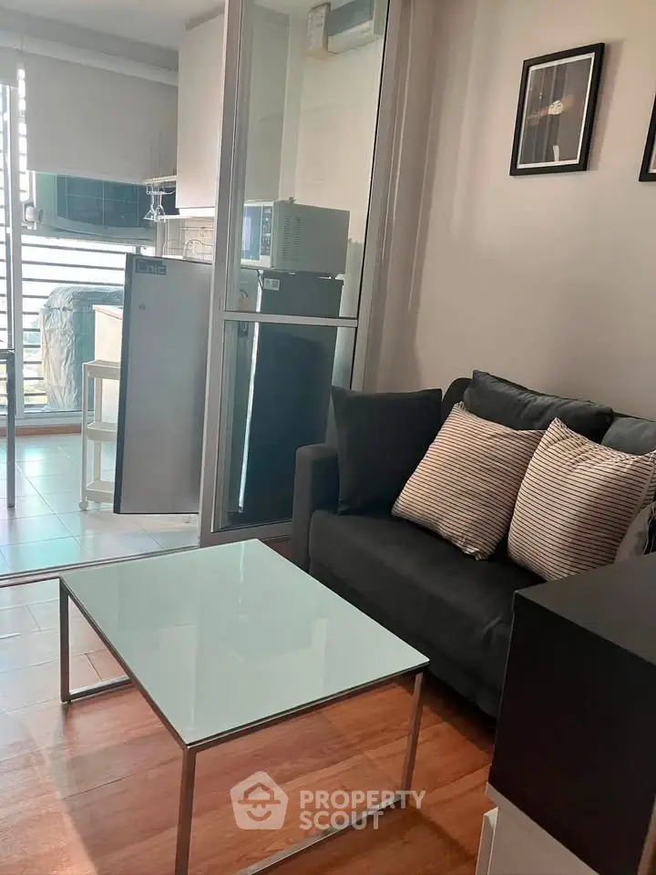 Modern living room with glass coffee table and cozy sofa in a stylish apartment.
