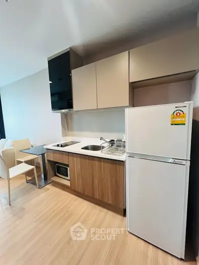 Modern kitchen with sleek cabinetry and appliances in a stylish apartment