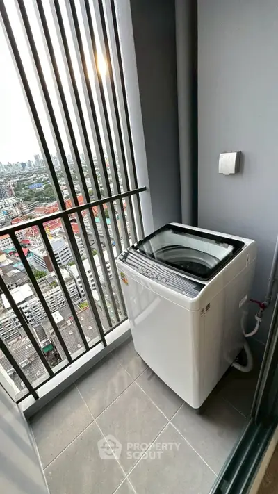 High-rise balcony with washing machine and city view