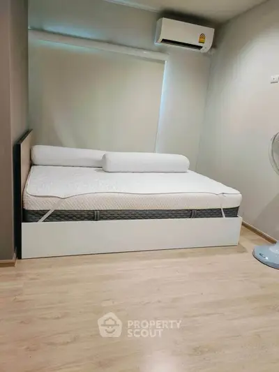 Modern bedroom with sleek design, featuring a comfortable bed and air conditioning for ultimate relaxation.