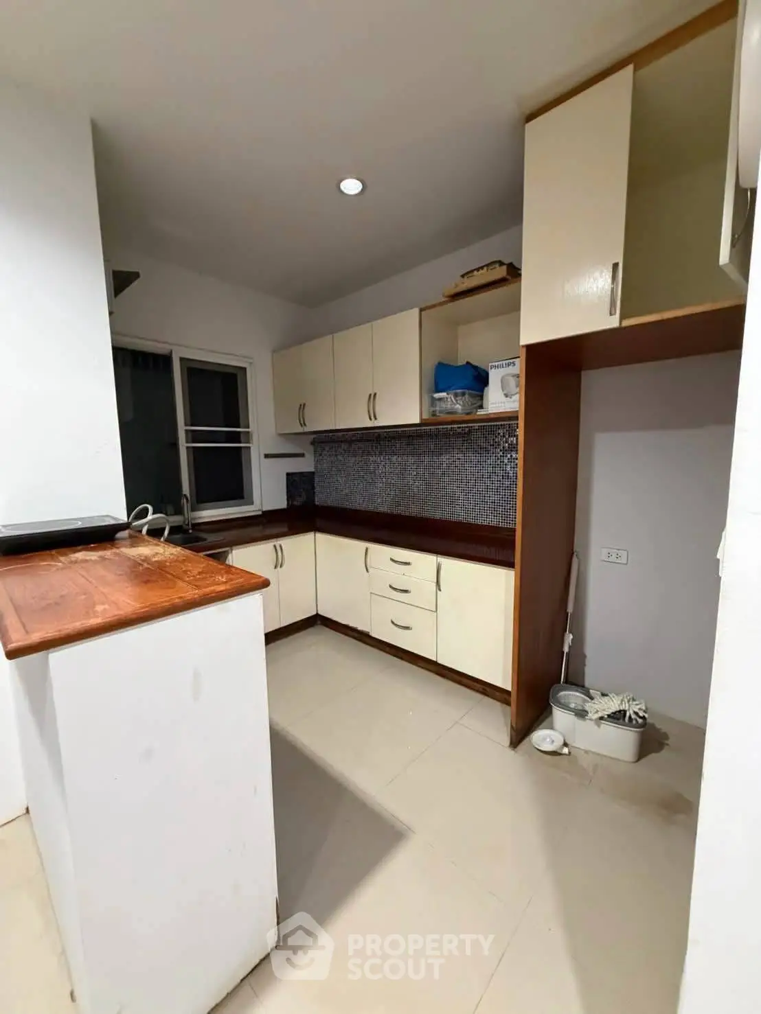 Modern kitchen with sleek cabinetry and tiled backsplash, perfect for culinary enthusiasts.