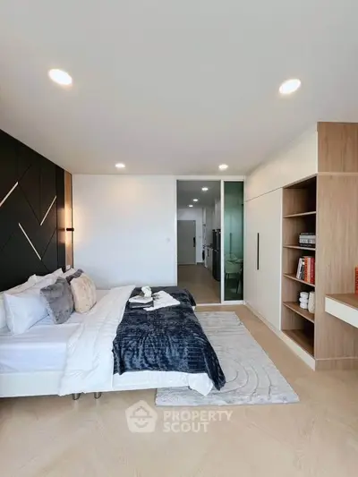 Modern bedroom with stylish decor and built-in storage in a contemporary apartment.
