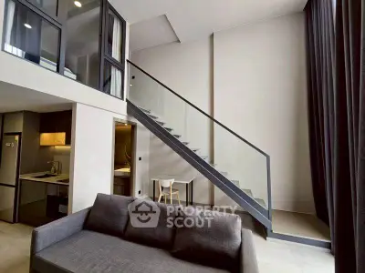 Modern loft apartment with sleek staircase and open kitchen layout
