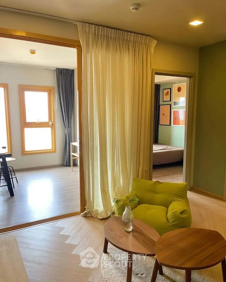 Stylish modern living room with green accents and cozy seating area, perfect for relaxation.