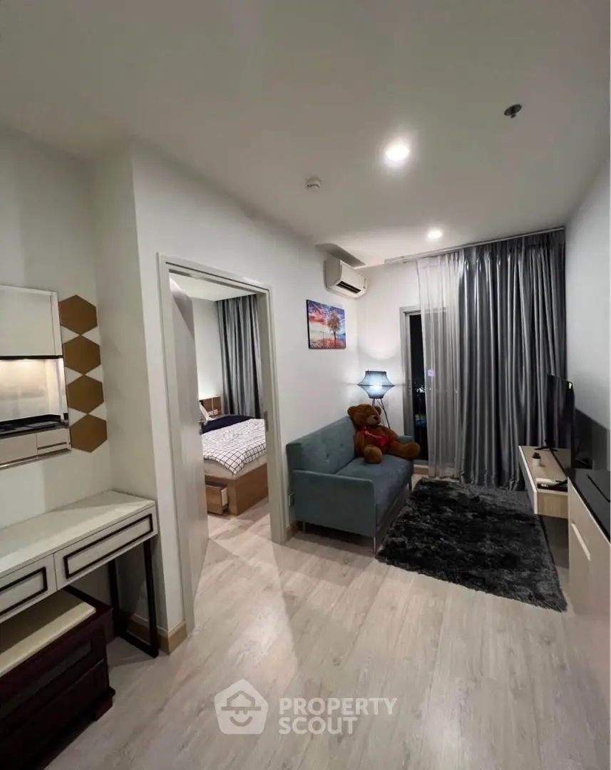 Modern apartment living room with cozy decor and bedroom view
