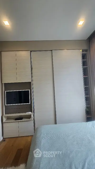 Modern bedroom with built-in wardrobe and cozy lighting