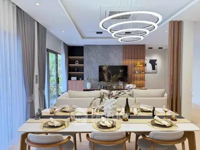 Luxurious open-plan living and dining area with modern decor and elegant lighting.