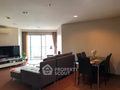 Spacious living room with modern furniture and balcony access