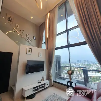 Luxurious high-rise living room with floor-to-ceiling windows and stunning city view.