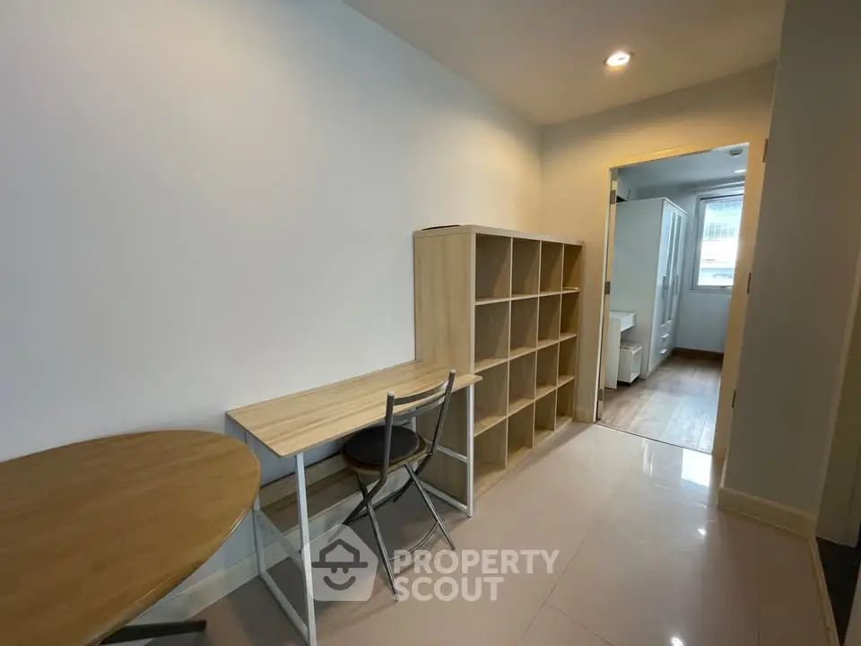 Modern study area with desk and shelving in a bright apartment