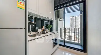 Modern kitchen with balcony view in high-rise apartment