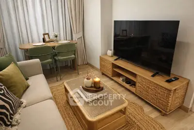 Cozy living room with modern decor, large TV, and stylish furniture, perfect for relaxation and entertainment.