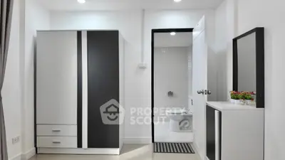 Modern minimalist bedroom with ensuite bathroom and sleek furniture