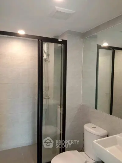 Modern bathroom with glass shower and sleek fixtures