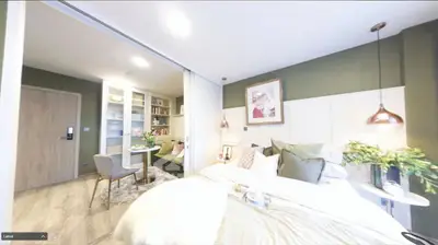 Modern bedroom with cozy decor and sliding doors leading to a stylish study area.