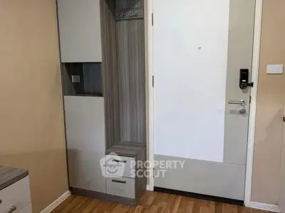 Modern apartment entrance with sleek storage and digital lock