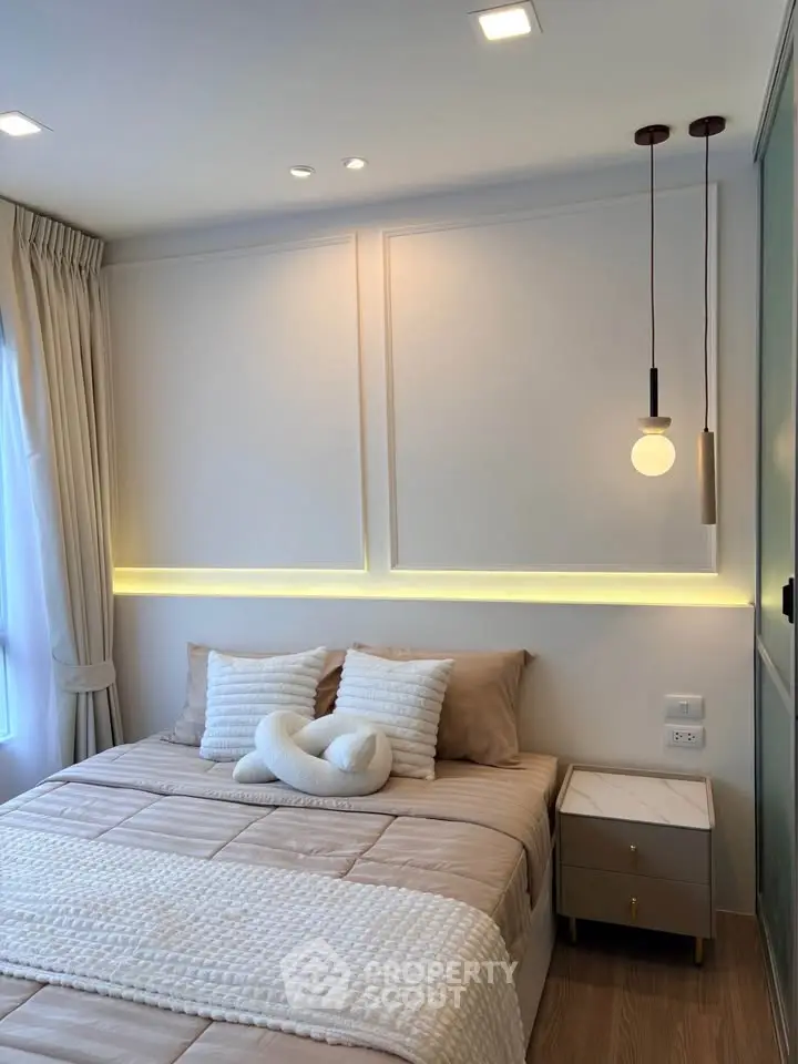 Elegant bedroom with modern lighting and cozy decor, perfect for relaxation and comfort.