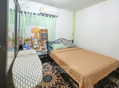 Cozy bedroom with air conditioning and decorative elements, perfect for a comfortable living experience.