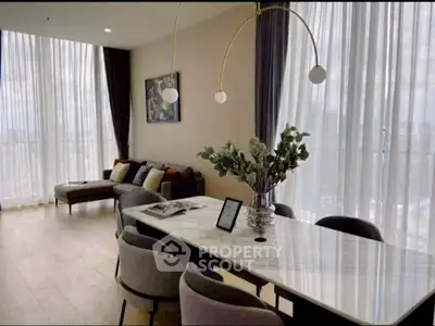 Elegant living room with modern decor and large windows