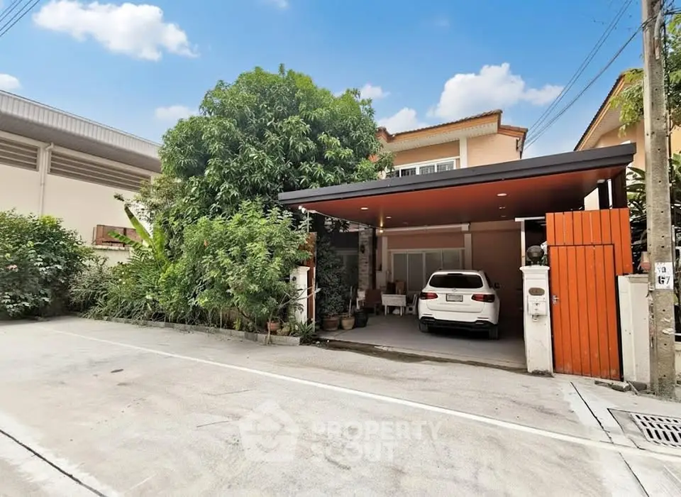 Charming suburban home with carport and lush greenery in a quiet neighborhood.
