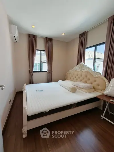 Elegant bedroom with luxurious bed and natural light, perfect for relaxation.