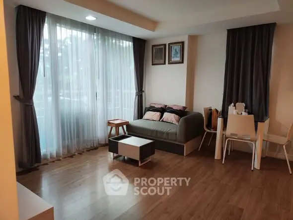 Cozy living room with modern decor and large windows for natural light.