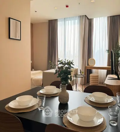 Modern dining area with elegant table setting and cozy bedroom view, perfect for stylish urban living.