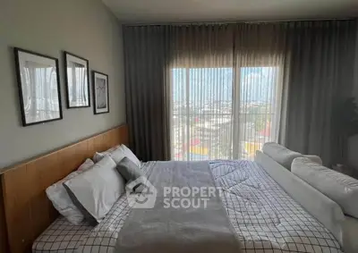 Spacious bedroom with large windows and modern decor, offering a serene and inviting atmosphere.
