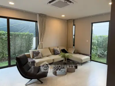 Modern living room with stylish furniture and garden view, perfect for relaxation and entertaining.