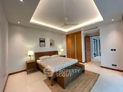 Spacious modern bedroom with elegant wooden furniture and ambient lighting