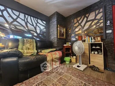 Cozy living room with unique wall design and comfortable seating