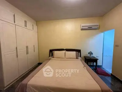 Cozy bedroom with built-in wardrobe and air conditioning, perfect for restful nights.