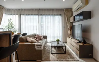 Modern living room with stylish decor and large windows for natural light.