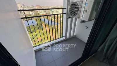 Charming balcony with city view and air conditioning unit, perfect for relaxation.