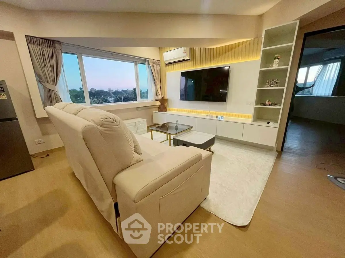 Modern living room with large window and stylish decor