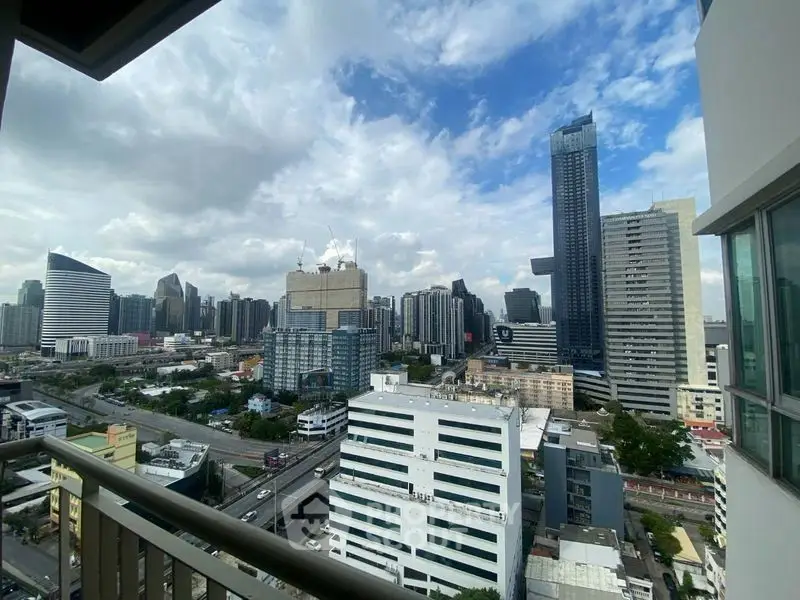 Stunning cityscape view from high-rise balcony in urban setting