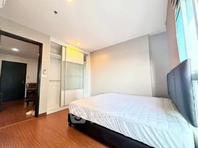 Spacious bedroom with modern design and ample natural light