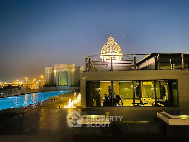 Luxurious rooftop pool with stunning city view and elegant architecture at dusk.