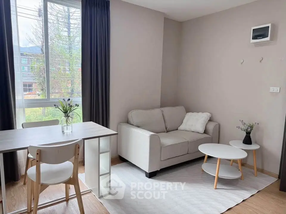 Cozy living room with modern furniture and large window view.