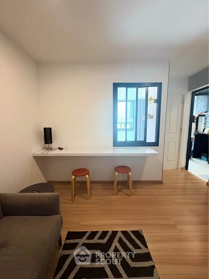 Modern living room with minimalist decor and wooden flooring