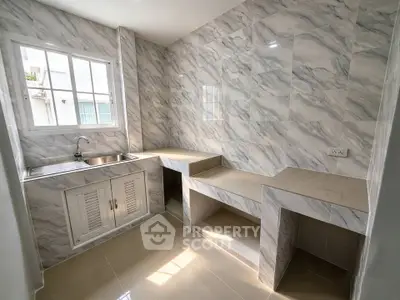 Modern kitchen with marble tiles and ample counter space